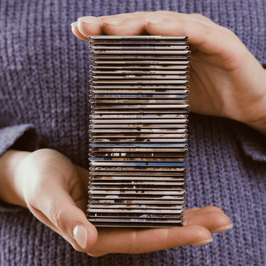 Custom photo magnets: sample magnet, stack of magnets in between hands