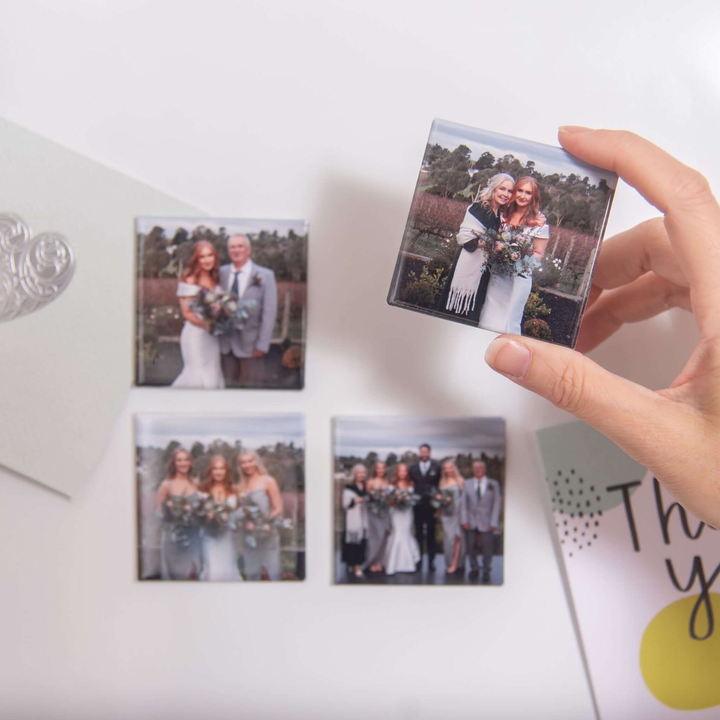 Custom photo magnets: wedding magnets on fridge with hand holding one magnet